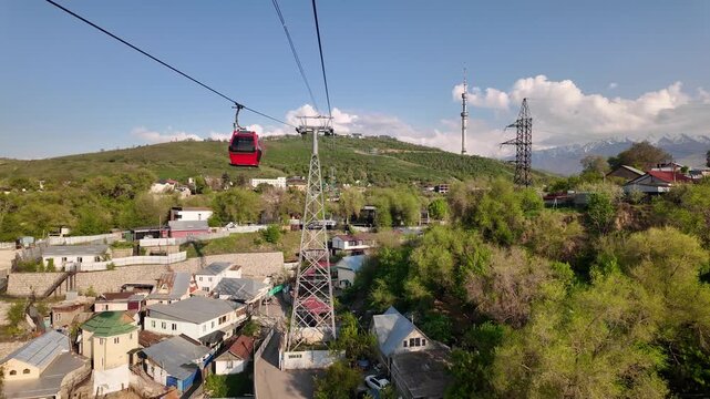 Almaty, Kazakhstan: Point of view of the cable car that rides up the Kok Tobe hill in Almaty, Kazakhstan largest city on a sunny spring day. 