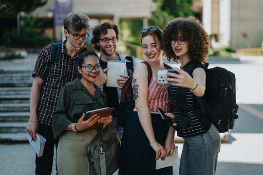 A diverse group of college students enjoying a moment together outdoors, taking a selfie on a sunny day. The image showcases academic camaraderie, joy, and school environment in a relaxed setting.