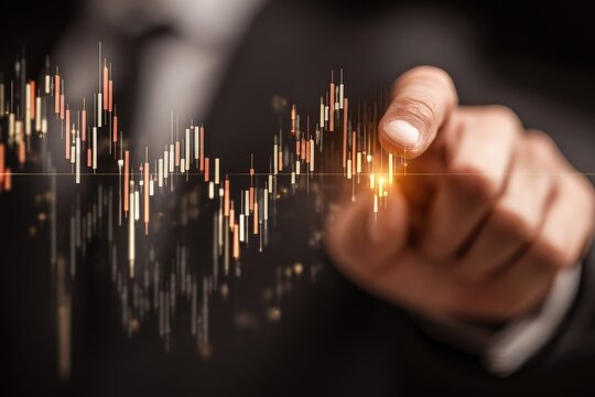 Business hand pointing at stock market chart