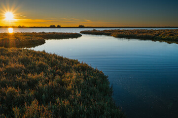 sunset over the lagoon, Po river delta, Comacchio, Ferrara, Italy