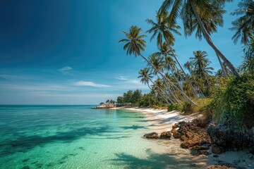 Tropical paradise beach with palm trees. Turquoise water laps a pristine white sand beach, edged with lush foliage and tall palm trees under a vibrant blue sky