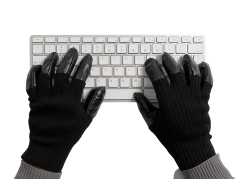 An overhead view captures a pair of hands, adorned in black gloves, actively engaged with a keyboard