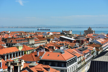 Naklejka premium Panorama of Lisbon, Portugal, with a view of the city's rooftops and the Tagus River in the background