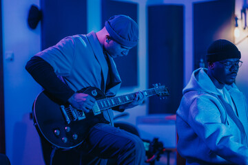 Diverse musicians are captured in a vibrant recording studio, collaborating and producing music. The image highlights creativity, teamwork, and the passion for musical innovation, showcasing an