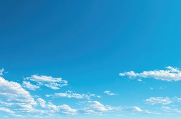 Fototapeta premium Clear, vibrant blue sky with scattered white clouds