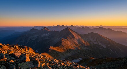 Experience the breathtaking panorama of jagged mountain peaks bathed in the warm glow of sunrise, perfect for travel blogs, adventure promotions, and scenic landscape designs