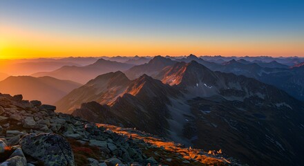 Fototapeta premium Stunning sunrise paints the rugged mountain peaks in warm golden light, inspiring adventure and exploration, perfect for travel, nature, and scenic landscape projects