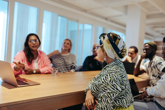 Multicultural creative agency team engaged in a dynamic meeting