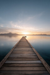 Stunning aerial view of a winding river cutting through lush green valleys under golden sunset light