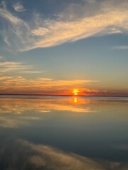 Golden Sunset Over Calm Water with Colorful Sky Reflections