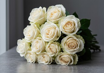 Obraz premium Elegant white roses bouquet floral arrangement indoor setting natural light soft aesthetic for weddings and celebrations