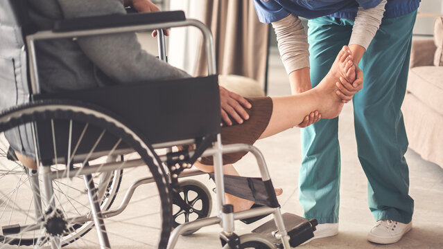 Physical therapist assisting a senior woman patient during a recovery - Powered by Adobe