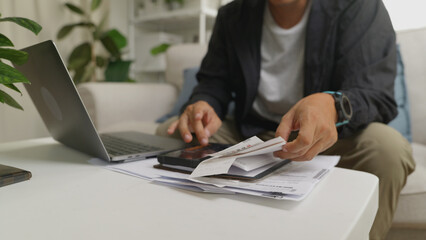 Close up hand Asian businessman sitting at a desk organizing bills and receipts.4k