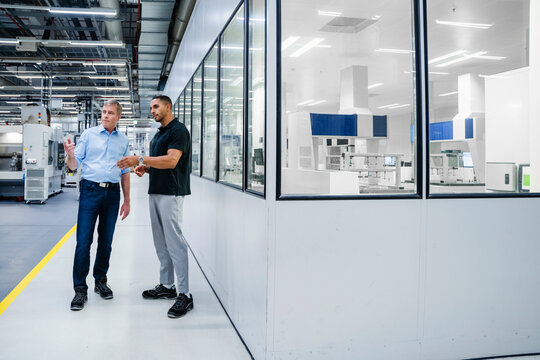 Businessman and employee having a discussion in a factory