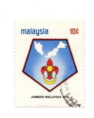 A vintage postage stamp from Malaysia isolated on a white background.