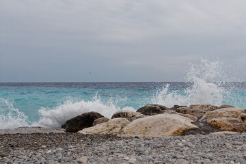 Sea waves and rocks on the beach. Nice, French Riviera, France