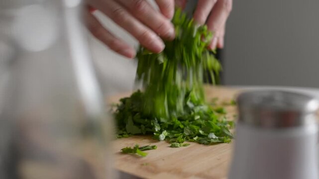 Chopping fresh herbs for a flavorful dish in a modern kitchen