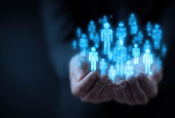 Close-up of a human hand holding a cluster of glowing blue holographic figures representing digital avatars or virtual people in a futuristic technology setting