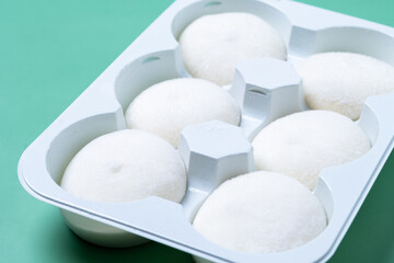 coconut ice cream mochi on green background