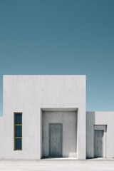 Modern concrete architecture featuring minimalist design with distinct openings under a clear blue sky in a tranquil outdoor setting during daylight