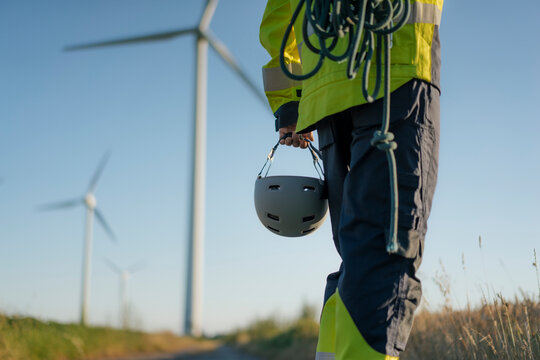 Close-up of technician at a wind farm with climbing equipment