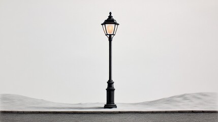 A solitary black lamp post over a snowy landscape creates a serene winter ambiance.