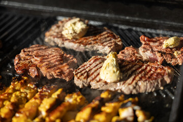 juicy beef steaks sizzling on a hot grill with seared marks, perfect for barbecue, outdoor cooking, summer party and delicious grilled meat cuisine concepts.