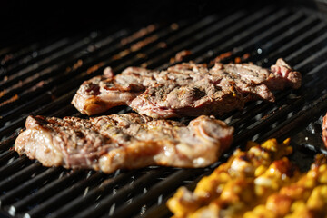 juicy beef steaks sizzling on a hot grill with seared marks, perfect for barbecue, outdoor cooking, summer party and delicious grilled meat cuisine concepts.