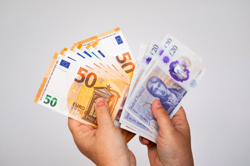 Close-up female hands counting uk pounds bills, paper money, British GBP banknotes, exchange and cashing currency, payments to fund, financial freedom, save up for vacation