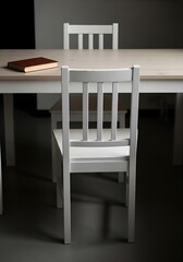 Simple White Dining Chairs and Table with Book