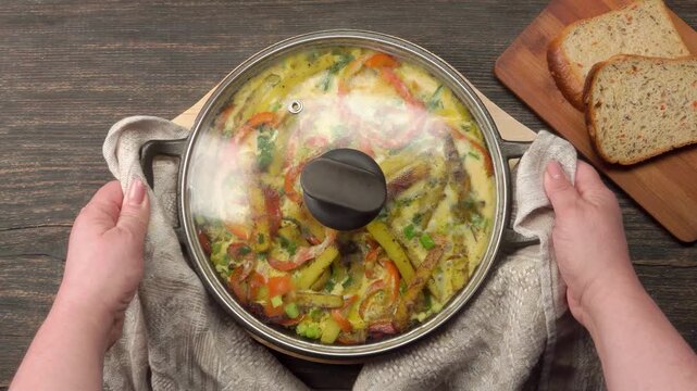 A finished, delicious frittata with potatoes, eggs, peppers, and onions in a frying pan. A perfect homemade, hearty, and colorful breakfast or brunch. Ready to be served