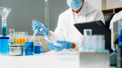 Scientist team meeting and writing analysis results in the laboratory study and analyze scientific sample