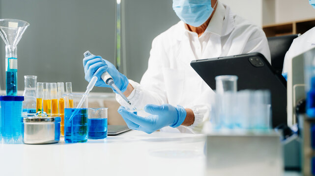 Scientist team meeting and writing analysis results in the laboratory study and analyze scientific sample