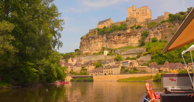 Beynac-et-Cazenac Village And Beynac Castle Seen From The Boat In Dordogne River In Beynac, France. - wide shot