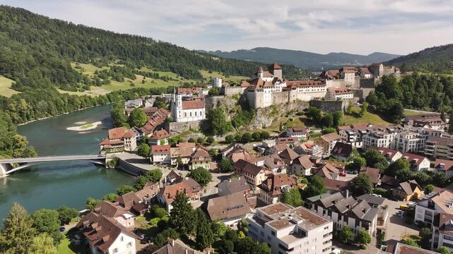 Aarburg castle perched on rock above Aare river in historic Aarburg town, Switzerland, beautiful drone alpine valley and medieval charm.