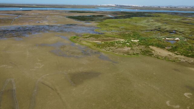 Ria Formosa with riverbed exposed at low tide in Algarve, Portugal