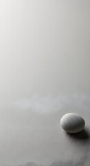 Single white stone on gray background