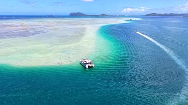 Panoramic of Kaneohe sandbar with tour boats in the water, summer aerial