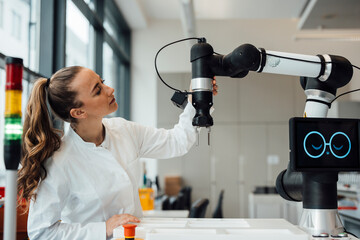 Scientist working with robotic arm in high tech medical laboratory