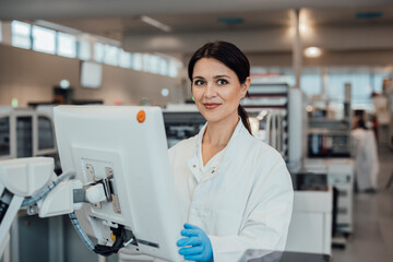 Scientist working with data on screen in modern laboratory clean room