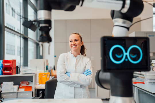 Scientist with AI supported robot in modern laboratory