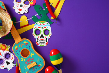 Mexican flat lay with sugar skull masks, sombrero, guitar, maracas, chili peppers, and garland on purple background. Perfect for Dia de los Muertos or festive cultural designs.