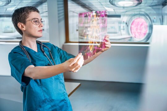Doctor analyzing holographic heart scan in futuristic hospital