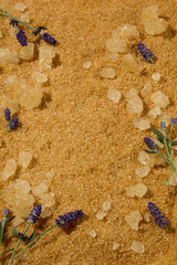 Close-up of brown sugar crystals and lavender buds, showcasing natural texture and scent for spa-inspired body care.