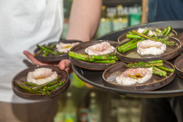 Serving of chicken salad on a plate with green asparagus on flatbread 202