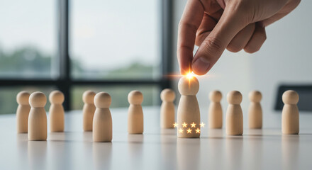 Hand placing wooden figure among others with stars in a bright office environment setting scene view