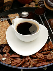 Espresso, sweets and nuts. Delicious snacks for aromatic coffee.