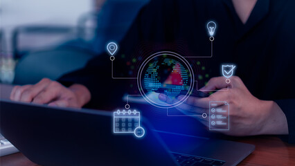 Person using laptop and smartphone with holographic icons for global technology and innovation