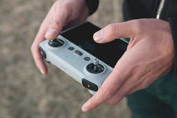 a man holding a remote controller in his hand.