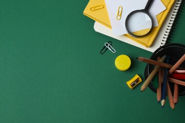 Back to school concept. Top view with school supplies on green background